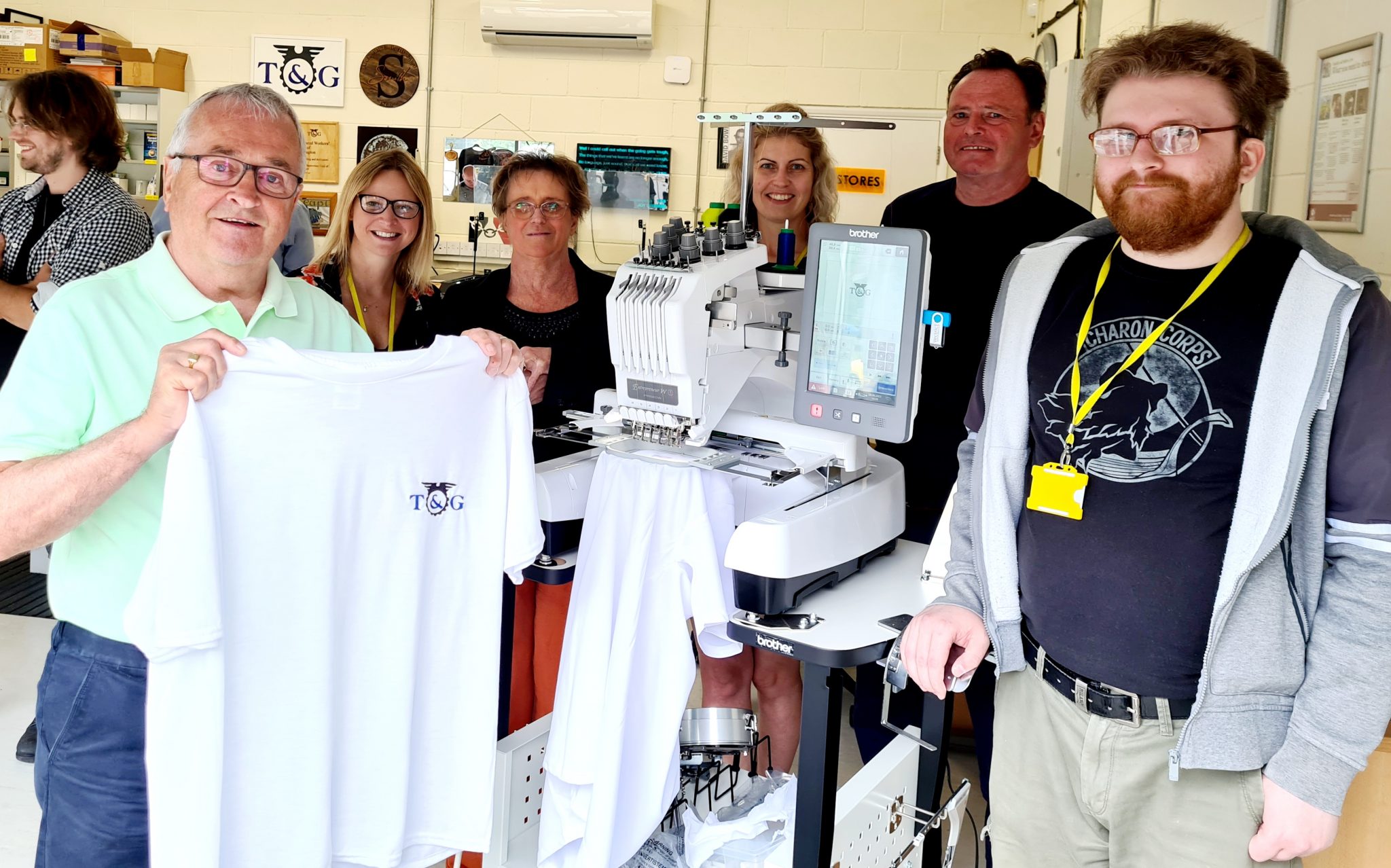 This shows Cyril on the left holding a t-shirt made in our Fab Lab 