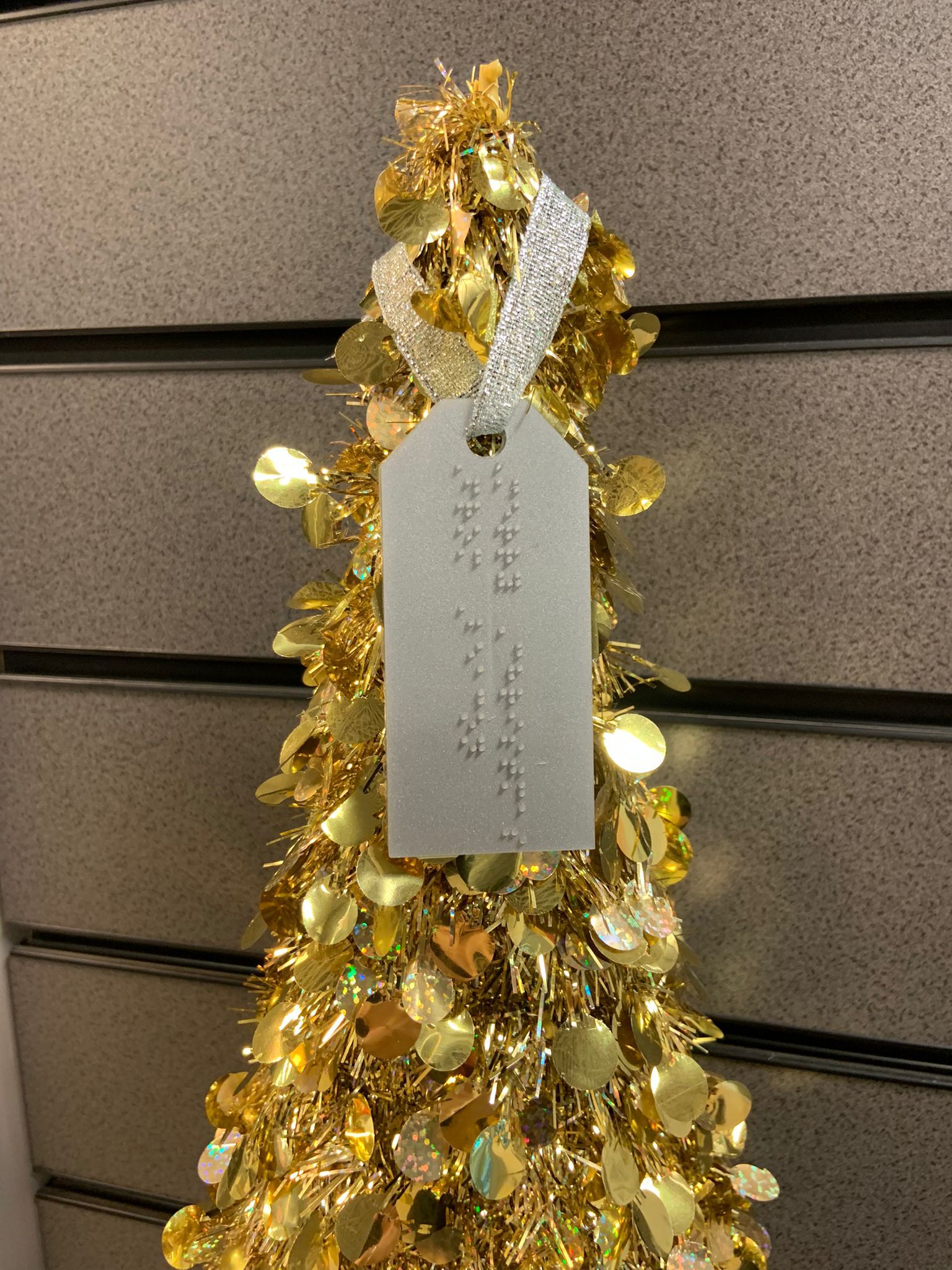 This shows a golden tree with a silver gift tag on which reads Merry Christmas from Kathy