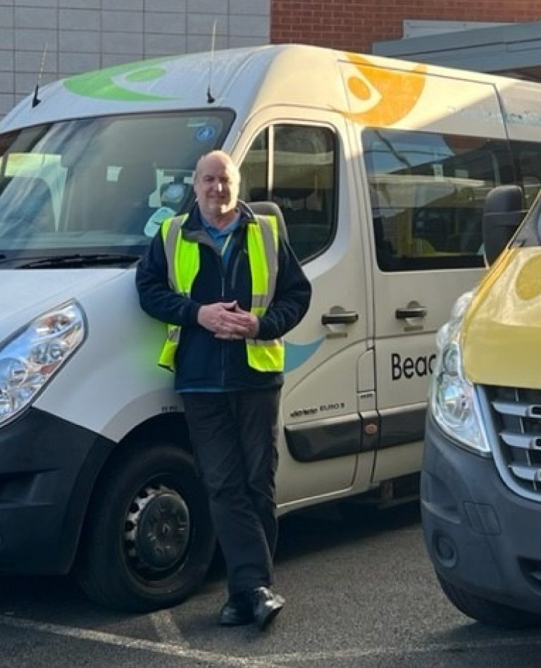 A man in a high-vis jacket stood outside the beacon vision van