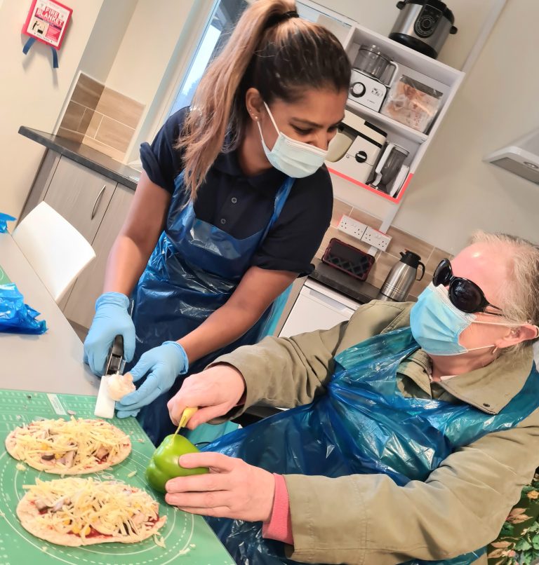 A service user learning to cook with sight loss