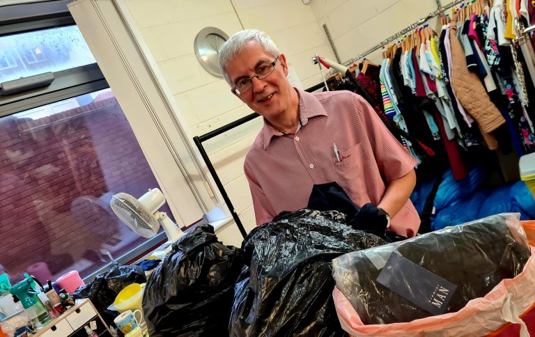 One of our shop team sorting some clothing.