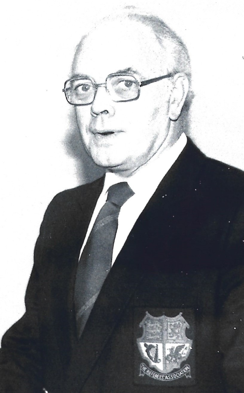 This is an older photograph of Walter, it is black and while and again he is wearing a suit and tiie. 